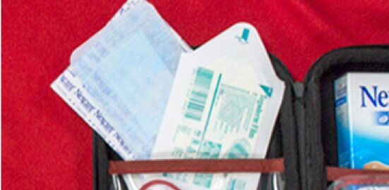 An open outdoor first-aid kit with Nexcare™ Sensitive Skin Adhesive Pads and Nexcare™ Tegaderm™ Transparent Dressings.
