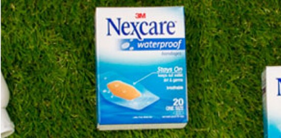 A package of Nexcare™ Waterproof Bandages on a lawn.
