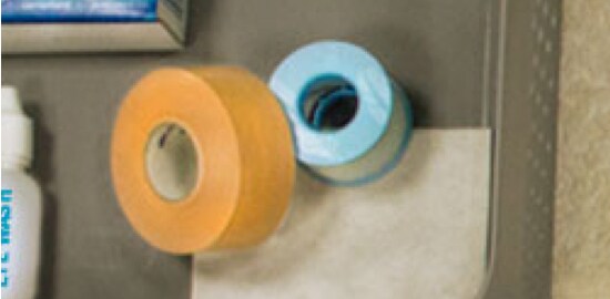 A home first aid kit with tapes in it.
