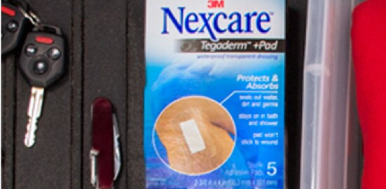 A box of Nexcare™ Tegaderm™ Pads on the bed of a truck.
